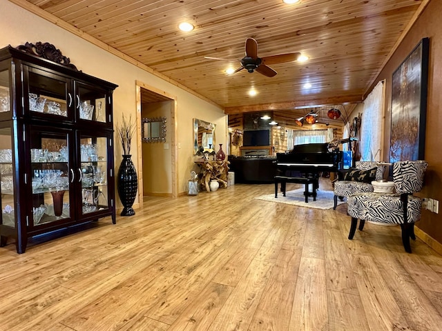 living area with a ceiling fan, recessed lighting, wood-type flooring, and wooden ceiling