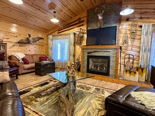 living area featuring wood ceiling, wooden walls, and vaulted ceiling