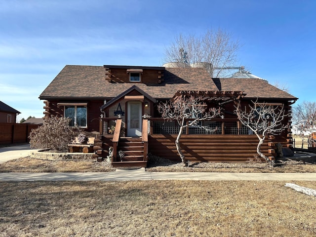 log home with roof with shingles and log siding