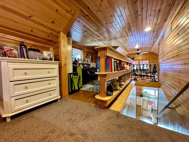 game room with lofted ceiling, ceiling fan, wood walls, carpet flooring, and wood ceiling