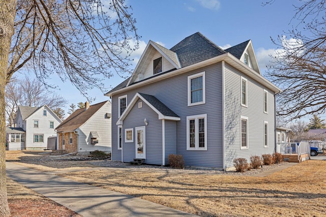 view of front of home with a shingled roof