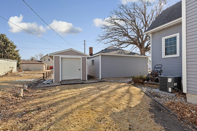 garage with a storage shed and cooling unit