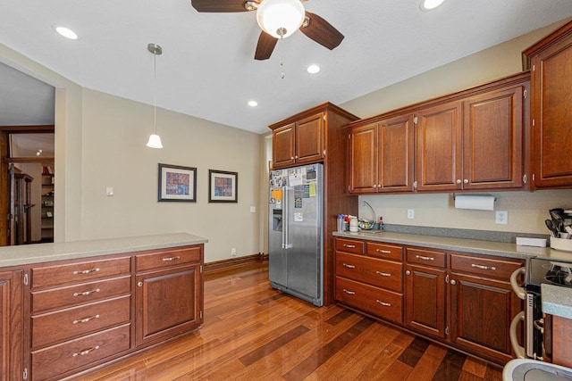 kitchen with recessed lighting, dark wood-style flooring, hanging light fixtures, appliances with stainless steel finishes, and light countertops