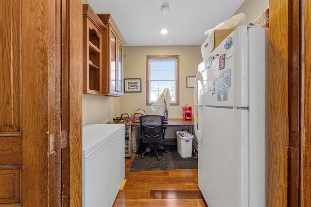 clothes washing area with wood finished floors