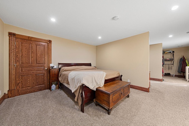 bedroom featuring light carpet, baseboards, and recessed lighting