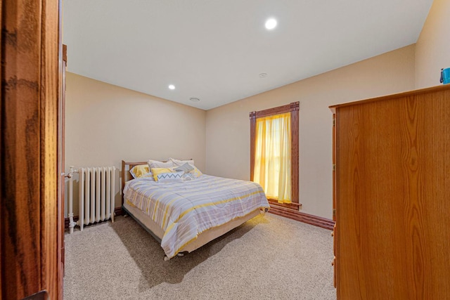 carpeted bedroom with radiator, baseboards, and recessed lighting