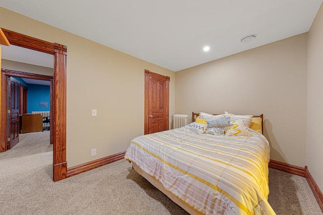 bedroom with baseboards, carpet floors, and radiator