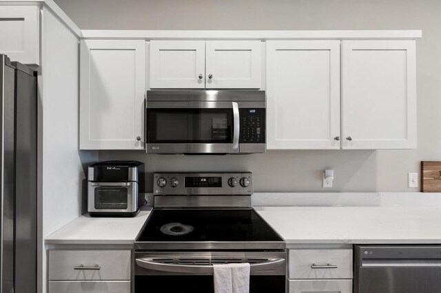 kitchen with white cabinetry and appliances with stainless steel finishes