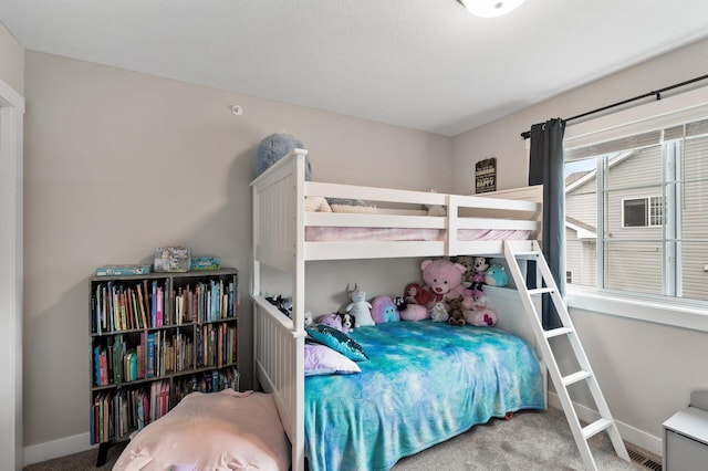 carpeted bedroom with baseboards