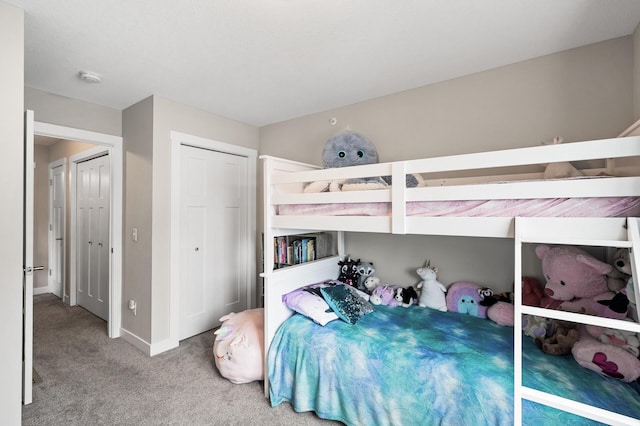 bedroom featuring carpet floors, a closet, and baseboards