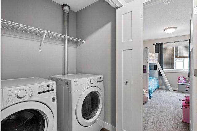 laundry area with laundry area, carpet flooring, washing machine and clothes dryer, and baseboards