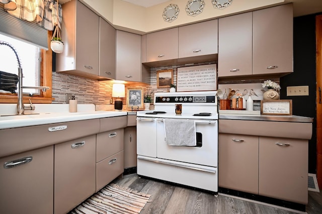 kitchen with decorative backsplash, white electric range, dark wood finished floors, and gray cabinetry