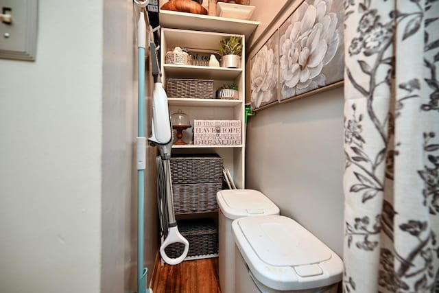 bathroom with toilet and wood finished floors