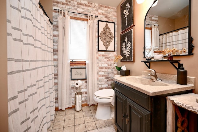 bathroom with toilet, tile patterned floors, brick wall, and vanity