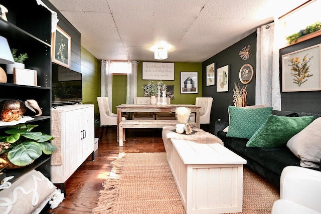 living area with a textured ceiling and wood finished floors