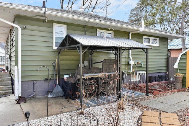 back of property with roof with shingles, a patio, and central AC