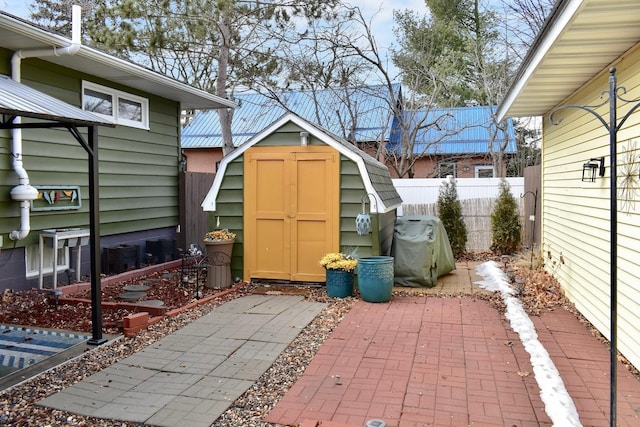 view of shed featuring fence