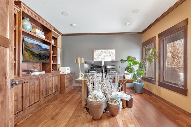 office with ornamental molding, light wood-style flooring, and baseboards