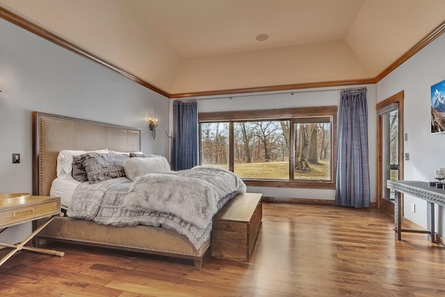 bedroom with baseboards, wood finished floors, and access to exterior