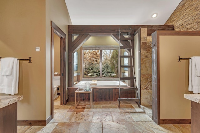 full bath featuring toilet, a garden tub, a tile shower, and stone tile flooring