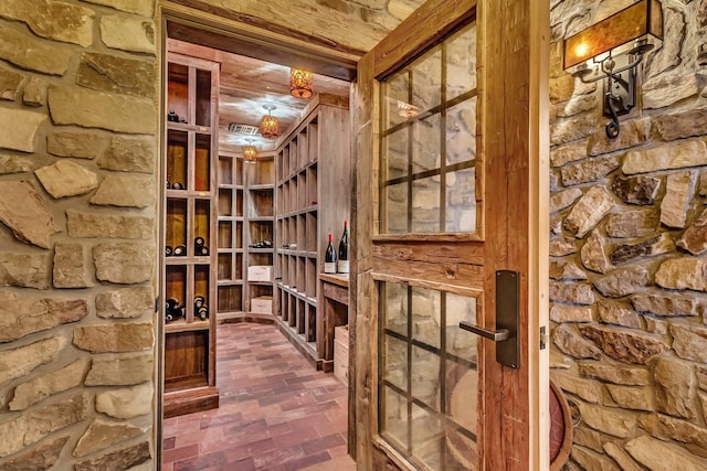 wine area featuring brick floor