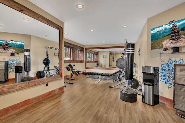 exercise room with recessed lighting, baseboards, and wood finished floors