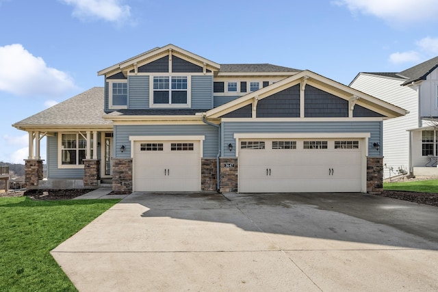 craftsman inspired home featuring an attached garage, driveway, and a front lawn