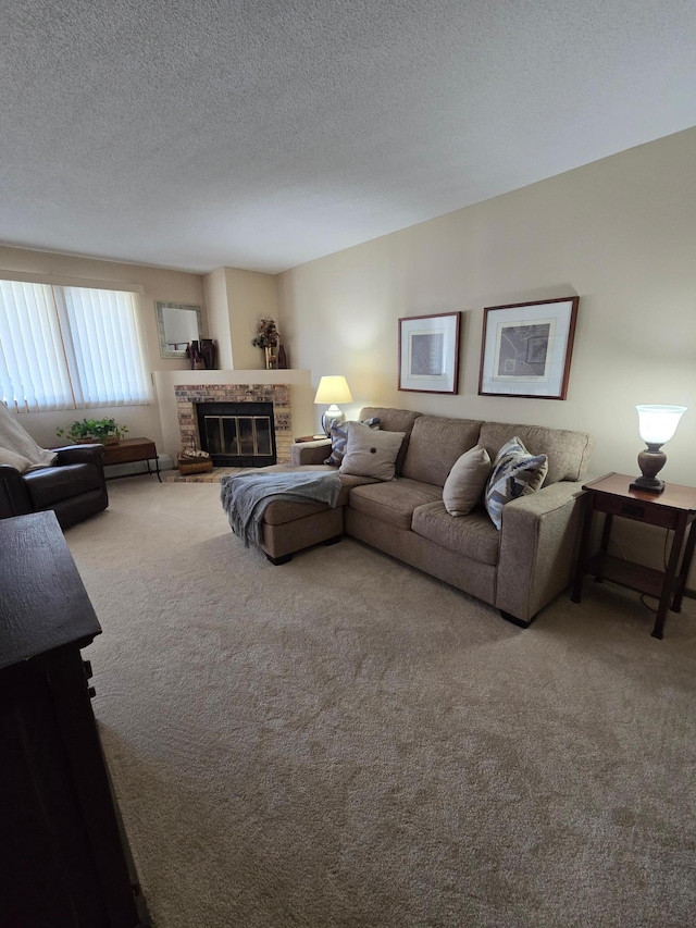 carpeted living room with a textured ceiling and a glass covered fireplace