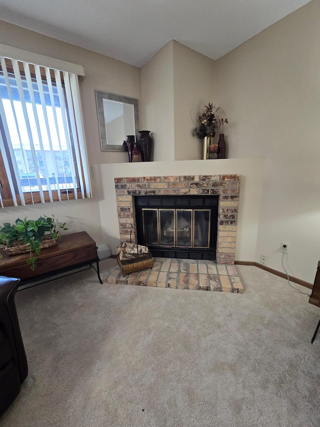 carpeted living area featuring baseboards and a fireplace