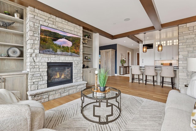 875 Lake St N Unit 402, Wayzata, MN 55391 - living room featuring recessed lighting, a fireplace, light wood finished floors, beamed ceiling, and baseboards
