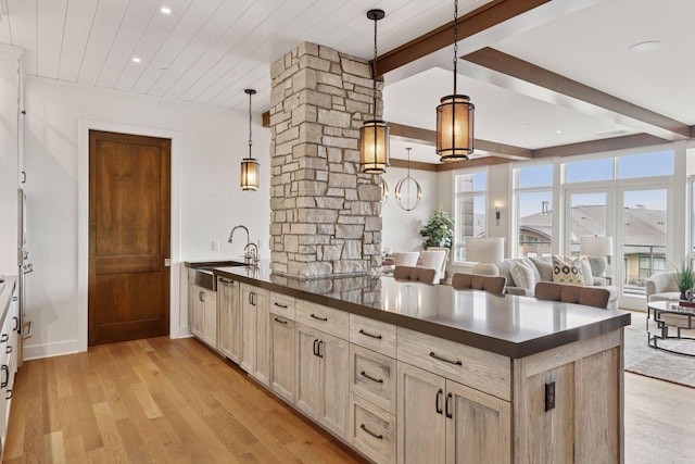875 Lake St N Unit 402, Wayzata, MN 55391 - kitchen with a sink, dark countertops, beam ceiling, light wood finished floors, and recessed lighting