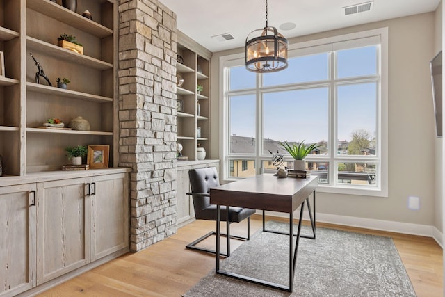 875 Lake St N Unit 402, Wayzata, MN 55391 - office area with a chandelier, light wood finished floors, baseboards, and built in shelves