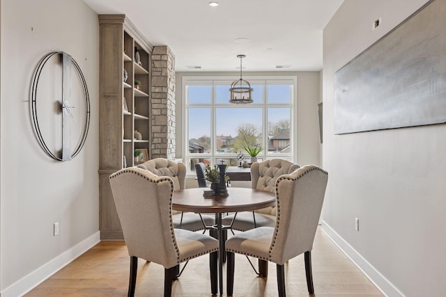 875 Lake St N Unit 402, Wayzata, MN 55391 - dining area featuring baseboards and light wood-style flooring