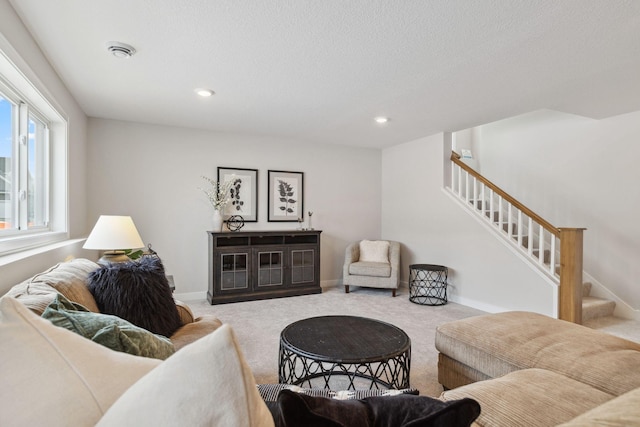 living room featuring stairs, baseboards, carpet flooring, and recessed lighting