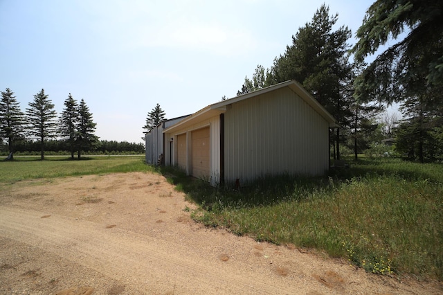 exterior space featuring an outdoor structure and a detached garage