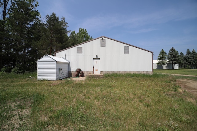 rear view of house with an outdoor structure