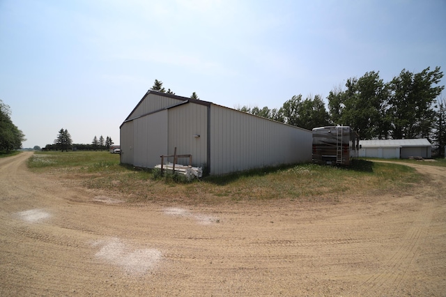 view of property exterior featuring an outbuilding and an outdoor structure