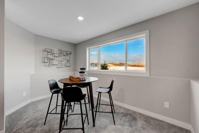 dining space with carpet and baseboards