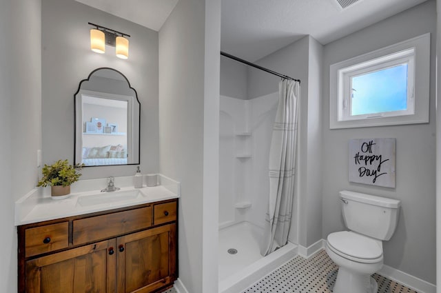 full bathroom with vanity, a shower stall, toilet, and baseboards