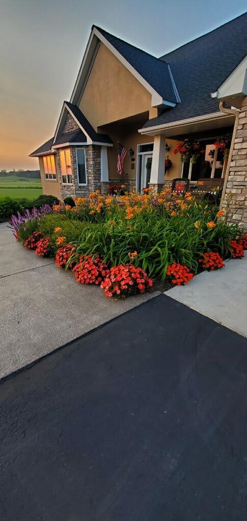 view of front of property featuring stone siding and stucco siding