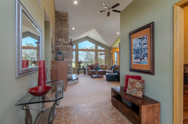 living area with visible vents, a ceiling fan, tile patterned flooring, carpet floors, and high vaulted ceiling