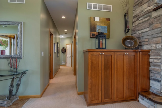 hallway featuring recessed lighting, baseboards, visible vents, and light colored carpet