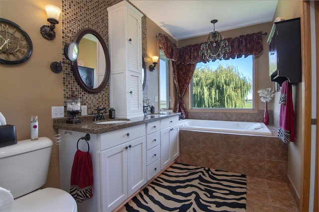 bathroom featuring decorative backsplash, a sink, toilet, and tile patterned floors