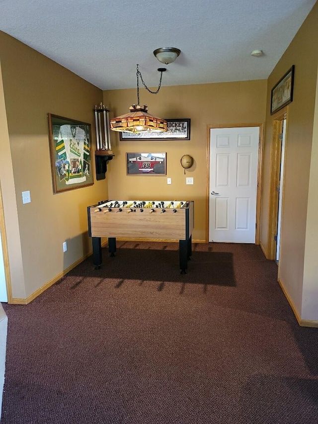 playroom with dark carpet and baseboards