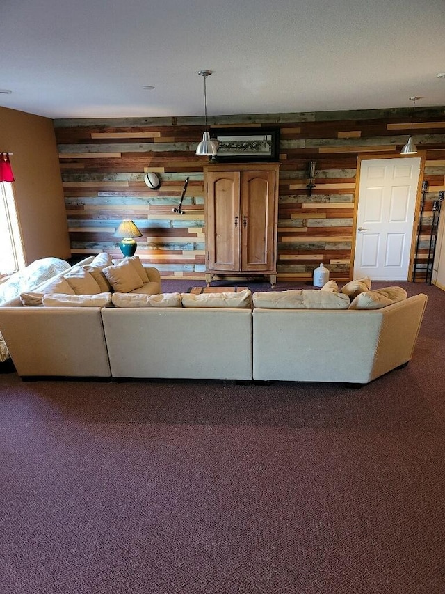 unfurnished living room featuring carpet and wooden walls