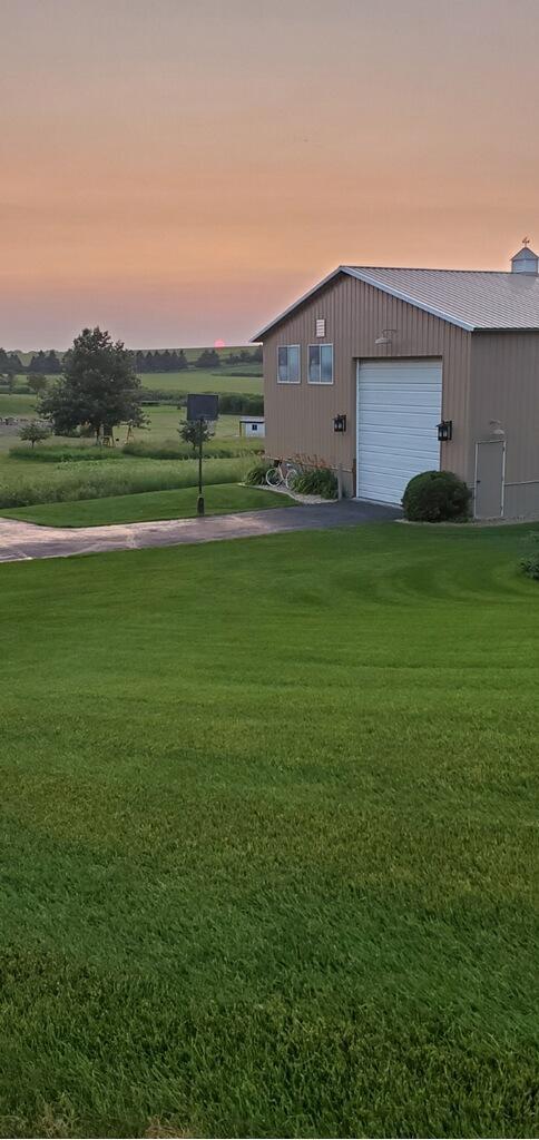 view of yard with a garage and an outdoor structure