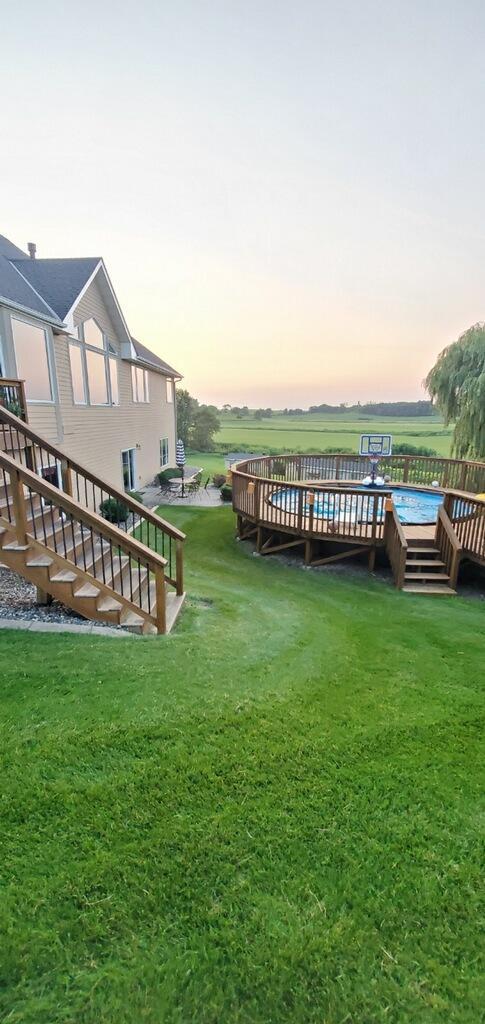 view of yard with a deck and stairway