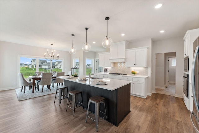 14355 Acer Ave, Rosemount, MN 55068 - kitchen featuring a breakfast bar, premium range hood, backsplash, oven, and light countertops