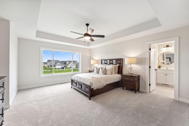 14355 Acer Ave, Rosemount, MN 55068 - bedroom featuring a tray ceiling, carpet floors, baseboards, connected bathroom, and ceiling fan