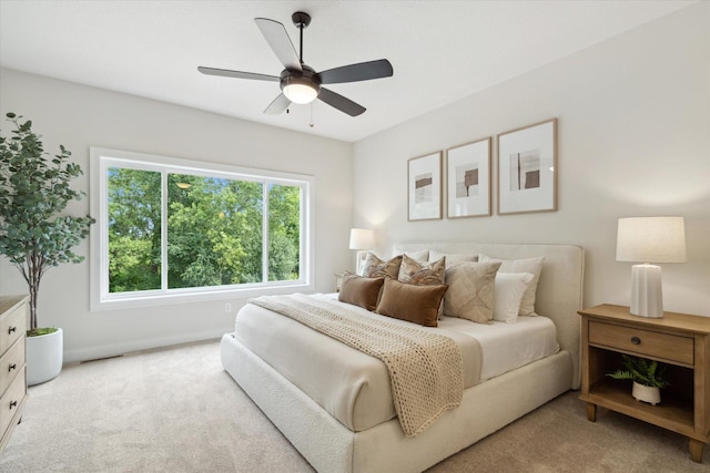 carpeted bedroom featuring baseboards and a ceiling fan